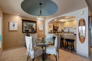 Coved ceiling with chandelier in dining room.