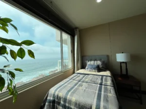 Secondary bedroom with a window overlooking the ocean