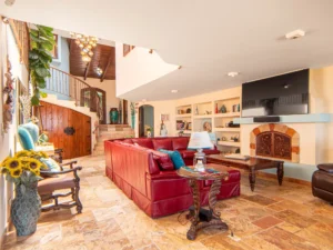 The living room features double-height ceilings.