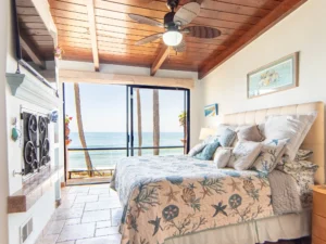 The primary suite opens onto the spacious oceanfront balcony.
