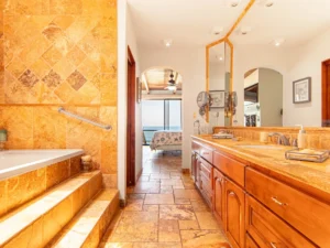 Spa-like bathroom with a jetted tub, double sinks, and separate shower