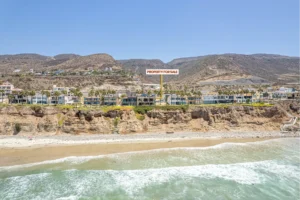The community has access to the sandy beach through shared stairs.