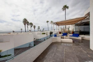 The patio includes custom glass railings.