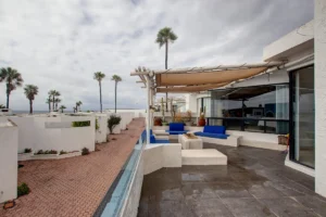 An expansive shade structure provides comfort and protection over the outdoor seating area.
