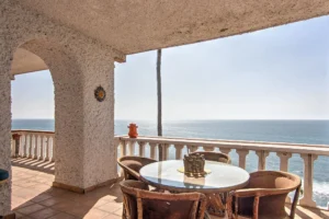 Oceanview patio with Saltillo tiles, arches, and space for lounging or barbecues.