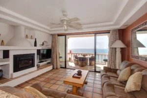 Features a cozy fireplace and a built-in entertainment center with decorative shelving.