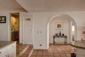 Beautiful arches and traditional Saltillo tile run throughout the condo