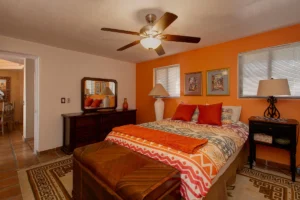The fully furnished second bedroom is spacious and colorful.