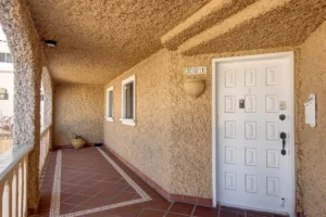 The covered walkway just beyond the front door extends behind the second bedroom, adding extra privacy.