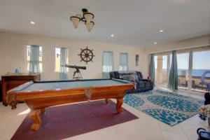 The lower-level living area includes a pool table.