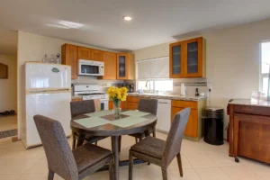 The modern kitchen incorporates a dining table.