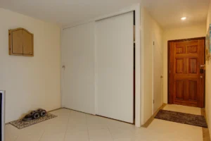 Entryway to the downstairs unit with a convenient closet.