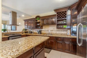 The kitchen comes complete with custom wood cabinetry, a dishwasher and granite countertops