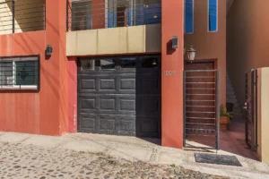 Entering from the cobblestone street is the principal entrance and the two-car tandem garage